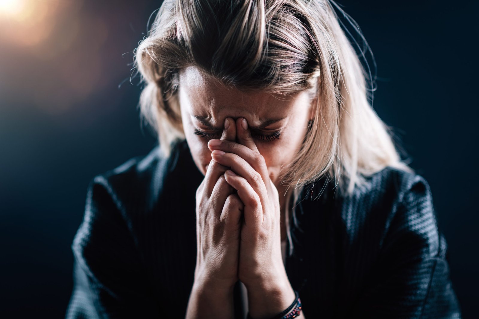 Anxious female face, portrait on a dark background