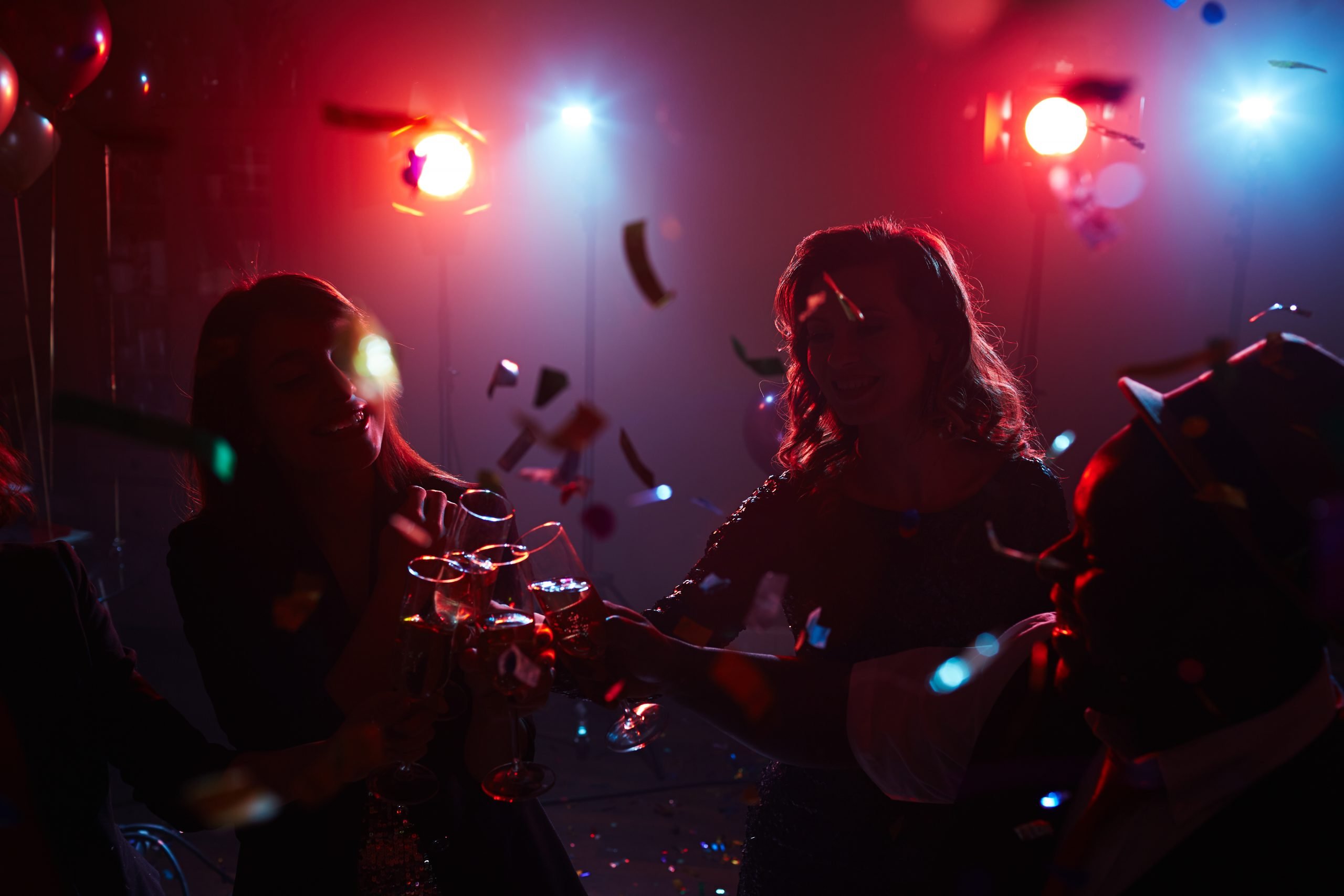 Happy group of friends toasting with flutes of champagne