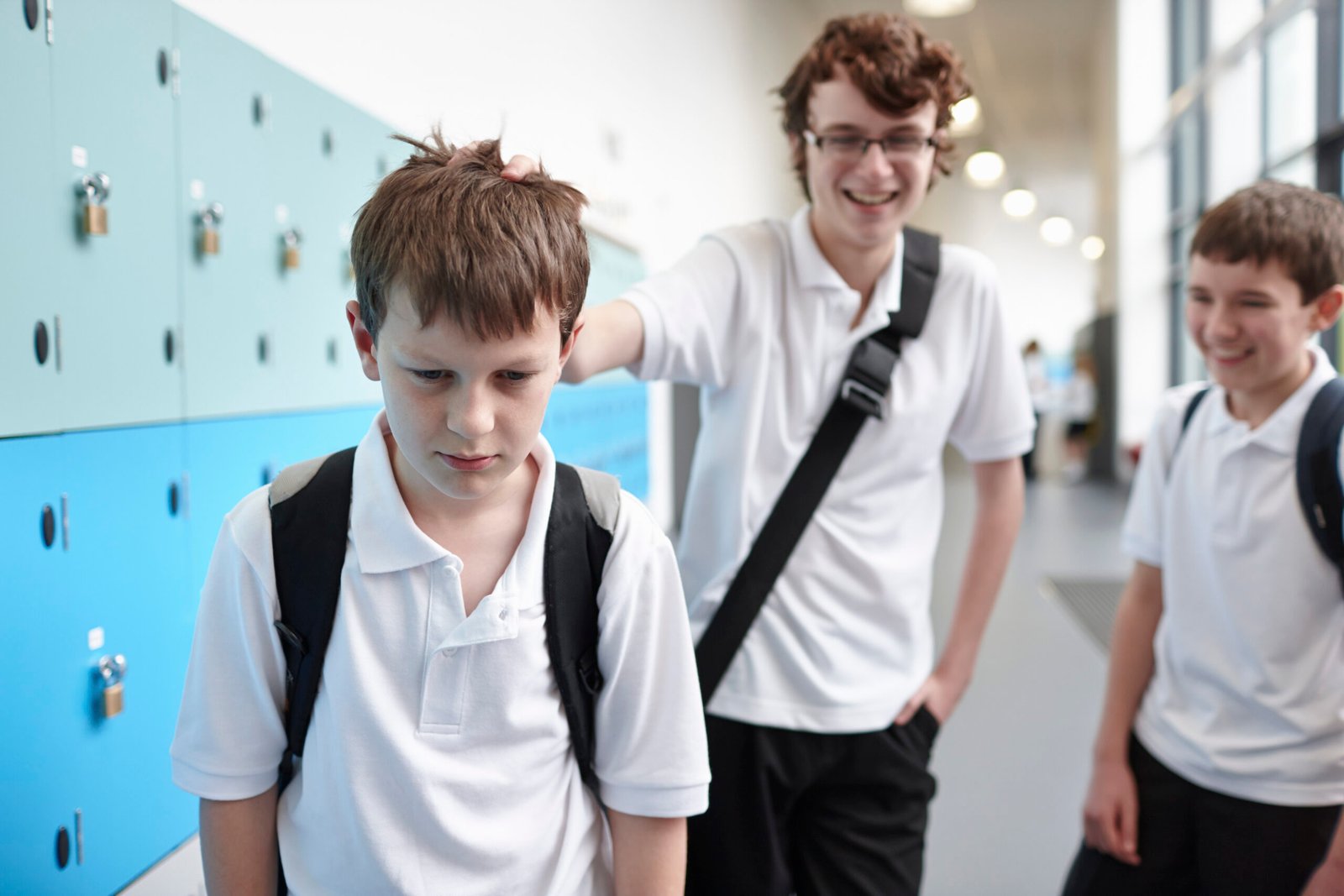 Schoolboy being bullied in school corridor