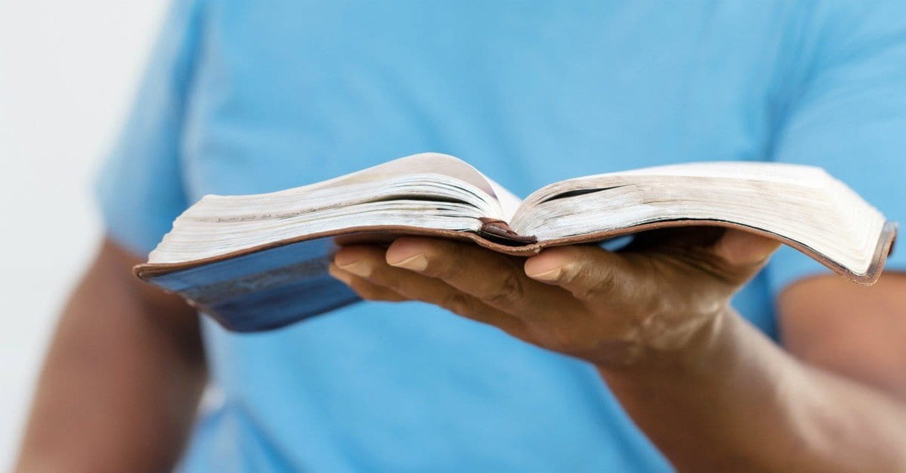 36897-manholdingBible-thinkstock.1200w.tn